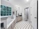 A traditional bathroom featuring a jacuzzi-style tub, and natural light at 715 Frog Rd, Locust Grove, GA 30248