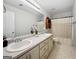 Bathroom with double vanity, large mirror, and a shower-tub combo with a shower curtain at 715 Frog Rd, Locust Grove, GA 30248