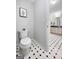 View of a secondary bathroom with a toilet and a sink that leads to the primary bathroom at 715 Frog Rd, Locust Grove, GA 30248