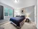 Bedroom featuring a queen bed, a large window with curtains and neutral-toned carpet at 715 Frog Rd, Locust Grove, GA 30248