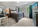 Spacious bedroom featuring a king-size bed, two windows, a dresser, and neutral-toned carpet at 715 Frog Rd, Locust Grove, GA 30248