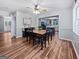 Cozy dining room with hardwood floors, a view to the kitchen and a charming ceiling fan at 715 Frog Rd, Locust Grove, GA 30248