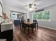 Bright dining room featuring hardwood floors, view to the kitchen and a large window at 715 Frog Rd, Locust Grove, GA 30248
