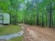 Wooded driveway leads through a beautiful, mature forest to this private home at 715 Frog Rd, Locust Grove, GA 30248