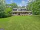 Charming home featuring a classic design with a wide, welcoming porch and manicured front lawn at 715 Frog Rd, Locust Grove, GA 30248