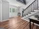 Lovely foyer featuring stained-glass sidelights, beautiful hardwood flooring and staircase at 715 Frog Rd, Locust Grove, GA 30248