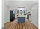 Open kitchen featuring hardwood floors, central island and white cabinets at 715 Frog Rd, Locust Grove, GA 30248