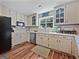 Traditional kitchen with stainless steel appliances, hardwood floors, and a window with lots of natural light at 715 Frog Rd, Locust Grove, GA 30248