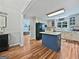 Spacious kitchen featuring hardwood floors, white cabinets, central island and modern appliances at 715 Frog Rd, Locust Grove, GA 30248