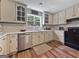 Traditional kitchen with stainless steel appliances, window, decor, and hardwood floors at 715 Frog Rd, Locust Grove, GA 30248