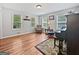 Comfortable living room featuring hardwood floors, a piano and bright, natural light at 715 Frog Rd, Locust Grove, GA 30248