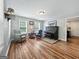 Relaxing living room with two windows, hardwood floors and a piano at 715 Frog Rd, Locust Grove, GA 30248