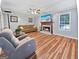 Spacious living room with hardwood floors, fireplace, large window and fan at 715 Frog Rd, Locust Grove, GA 30248