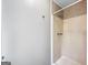 White bathroom includes a shower, white walls, and chrome fixtures at 401 Grove Pointe Ct, Locust Grove, GA 30248