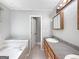 Bathroom featuring a vanity, tub, and tiled flooring at 401 Grove Pointe Ct, Locust Grove, GA 30248