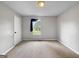 Neutral bedroom with carpet flooring, ceiling fan, and a window at 401 Grove Pointe Ct, Locust Grove, GA 30248