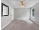 Neutral bedroom with carpet flooring, ceiling fan, and a mirror on the wall at 401 Grove Pointe Ct, Locust Grove, GA 30248