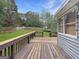 Wide deck overlooks fenced back yard at 401 Grove Pointe Ct, Locust Grove, GA 30248
