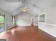 Open living space with hardwood floors, vaulted ceiling, and lots of natural light at 401 Grove Pointe Ct, Locust Grove, GA 30248