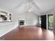 Bright living room with hardwood floors, stone fireplace, and vaulted ceilings at 401 Grove Pointe Ct, Locust Grove, GA 30248