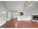 Open-concept living area with fireplace and hardwood floors flowing into dining area at 401 Grove Pointe Ct, Locust Grove, GA 30248
