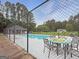 Community pool area with seating and shade, perfect for relaxation and recreation at 401 Grove Pointe Ct, Locust Grove, GA 30248