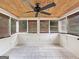 Bright sunroom with wood ceiling, ceiling fan, tile floors, and window shades at 401 Grove Pointe Ct, Locust Grove, GA 30248