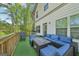 Outdoor deck with wicker sofa, chairs, grill, and fire pit table overlooking wooded area at 5237 Halcyon Ct, Morrow, GA 30260