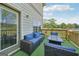 Outdoor deck with wicker sofa, chairs, and fire pit table overlooking a green space and beautiful blue skies at 5237 Halcyon Ct, Morrow, GA 30260