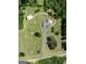 Stunning aerial view of a home with a circular driveway and large acreage surrounded by mature trees at 382 Knox Chapel Rd, Social Circle, GA 30025
