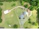 Overhead view of the house showcasing the surrounding greenery, long driveway, and outbuildings at 382 Knox Chapel Rd, Social Circle, GA 30025