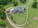 Aerial shot showcasing a well-maintained home with a spacious yard and additional outbuildings at 382 Knox Chapel Rd, Social Circle, GA 30025