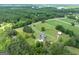 Stunning aerial view featuring the home, property, pastures, and surrounding wooded area and lake at 382 Knox Chapel Rd, Social Circle, GA 30025