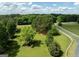 Scenic aerial view of a property with expansive green lawns, white fencing, and mature trees at 382 Knox Chapel Rd, Social Circle, GA 30025