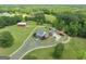 Aerial view of the beautiful home, barn, and surrounding acreage with white fencing at 382 Knox Chapel Rd, Social Circle, GA 30025