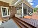 Inviting back porch with a screened-in area, outdoor seating, and a wooden deck, perfect for relaxation and entertaining at 382 Knox Chapel Rd, Social Circle, GA 30025