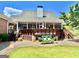 Beautiful backyard with a spacious deck, complemented by landscaped elements and an inviting outdoor seating area at 382 Knox Chapel Rd, Social Circle, GA 30025