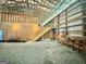 Spacious barn interior features open wood-beam framing, stairs, and gravel floor at 382 Knox Chapel Rd, Social Circle, GA 30025