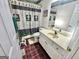 Small bathroom with tiled floors, framed mirror, and shower with golf-themed curtain at 382 Knox Chapel Rd, Social Circle, GA 30025