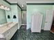 Spacious bathroom features dual vanity, walk-in shower, green marble-look tile, and a white wicker cabinet at 382 Knox Chapel Rd, Social Circle, GA 30025