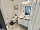 Cozy bathroom features a classic design with white fixtures, a vanity, and a toilet, offering essential functionality at 382 Knox Chapel Rd, Social Circle, GA 30025