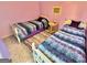 Cozy bedroom features two twin beds with colorful bedding and a shared nightstand at 382 Knox Chapel Rd, Social Circle, GA 30025