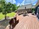 Expansive backyard deck featuring built-in seating and outdoor dining, all surrounded by a lush lawn at 382 Knox Chapel Rd, Social Circle, GA 30025