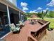 Outdoor deck area with patio furniture, seating, and a view of the surrounding greenery and barn at 382 Knox Chapel Rd, Social Circle, GA 30025