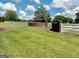 Grand entrance to the property featuring brick columns, fencing, and a long driveway at 382 Knox Chapel Rd, Social Circle, GA 30025