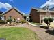 Attractive brick home featuring a well-manicured lawn, mature trees, and a walkway leading to the entrance at 382 Knox Chapel Rd, Social Circle, GA 30025