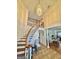 Grand foyer featuring an elegant staircase, chandelier, and views into the living room at 382 Knox Chapel Rd, Social Circle, GA 30025