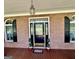 Charming entryway with a decorative glass front door, brick walls, and elegant light fixture at 382 Knox Chapel Rd, Social Circle, GA 30025