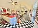 Bright game room featuring a pool table, bar area, and checkered flooring, ideal for entertaining and recreation at 382 Knox Chapel Rd, Social Circle, GA 30025