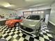 Spacious garage featuring checkered flooring and housing two cars for convenient parking and stylish appeal at 382 Knox Chapel Rd, Social Circle, GA 30025